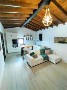 a living room with a white couch and a table at Villa Aura in La Sorrueda