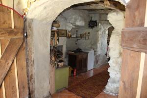 a kitchen with an archway in a stone wall at Suur-Lossi Apartments in Haapsalu