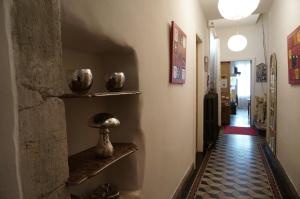 a hallway with vases on shelves on the wall at Maison Bersane in Le Poujol-sur-Orb