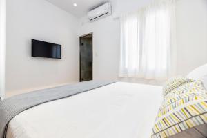 Postel nebo postele na pokoji v ubytování Pelican Paros