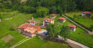an aerial view of a house with a train at Ethno Village Bogut in Bogutovac