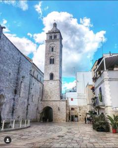 a large building with a clock tower on it at Kofler GuestHouse in Barletta