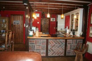 a bar in a room with a brick wall at Barn Cottage - Farm Park Stay with Hot Tub in Swansea