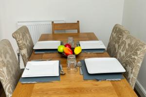 a wooden table with three laptops on top of it at Hepburn House in Salisbury