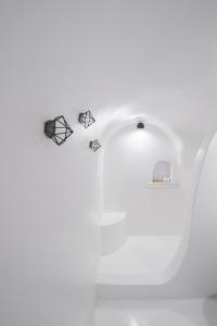 a close up of a white toilet with its handle at Nano Oia Villas in Oia