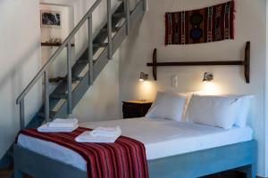 a bed in a room with a staircase at Arhondiko in Sougia