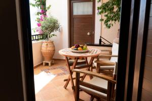 a table with a bowl of fruit on a balcony at Arhondiko in Sougia +33 photos
