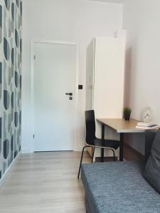 a room with a desk and a table and a door at Rooms4Less in Gdańsk +7 photos