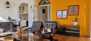 a living room with two chairs and a table at Risto Apartment in Skopje