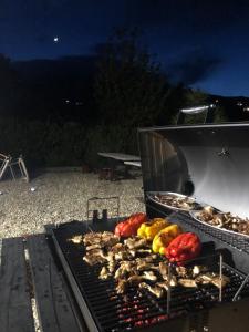 a grill with meat and vegetables on it at night at Etna Blick View in Zafferana Etnea