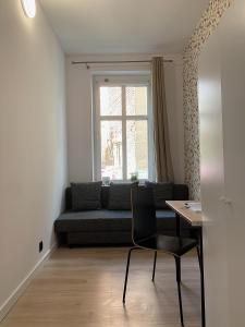 a living room with a couch and a table at Rooms4Less in Gdańsk