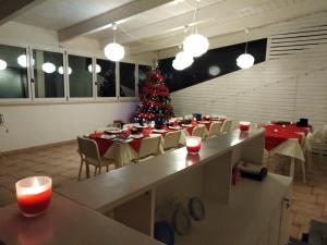 a dining room with a christmas tree in the middle at Il Falco e Il Gabbiano in Corigliano Calabro