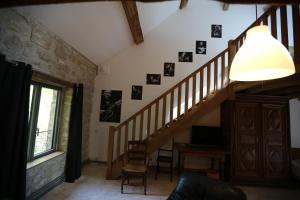 a room with a staircase with pictures on the wall at LE DOMAINE DE MONA - Gîte de caractère in Cergy