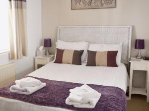 a bedroom with a bed with white towels on it at The Coracle in Ironbridge