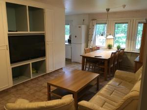 a living room with a kitchen and a dining room at House in the heart of Lapland P4 in Puoltikasvaara