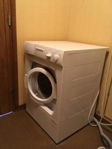 a washer and dryer in the corner of a room at House in the heart of Lapland P4 in Puoltikasvaara