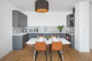 a kitchen with a white table and chairs at Clarence Square in Brighton & Hove