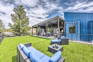 a backyard with a blue house with a lawn at Casa Patron Home Less Than 10 Mi to Hiking and Casinos in Alto