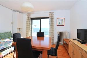 a dining room with a table and a television at Apartamentos Zodiac in Lloret de Mar