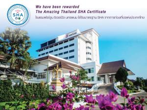 a building with purple flowers in front of it at Fortune River View Hotel Nakhon Phanom in Nakhon Phanom