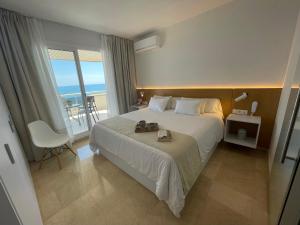 a bedroom with a bed with a view of the ocean at Mediterraneo Sitges in Sitges
