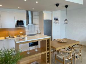 a kitchen and dining room with a table and chairs at Mediterraneo Sitges in Sitges