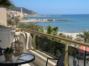 a beach scene with a balcony overlooking the ocean at Mediterraneo Sitges in Sitges