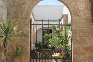 an archway in a building with plants at Lo Studio - Camilla's Guesthouse in Morciano di Leuca +31 photos