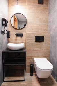 a bathroom with a white sink and a mirror at Lofft Hotel in Ciechanów