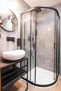 a bathroom with a sink and a shower at Lofft Hotel in Ciechanów