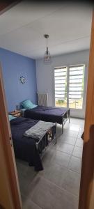 Ένα ή περισσότερα κρεβάτια σε δωμάτιο στο Chez maman +9 φωτογραφίες