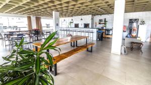 a restaurant with a wooden table and chairs and a cafeteria at Hotel & Pousada Favareto in Florianópolis