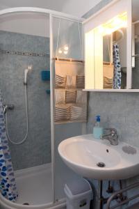 a bathroom with a sink and a shower at Spacious Piran Central Apartment for 5 Pax BG in Piran