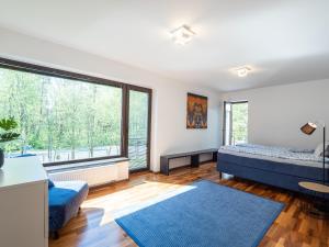 a bedroom with two beds and a large window at Pärnu Family House in Pärnu