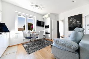 a living room with a couch and a table at Lauris Luxury Apartment Zadar in Zadar