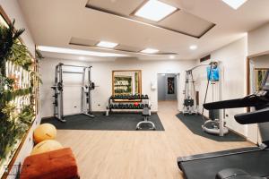 a gym with two treadmills and weights at KERCULLA Resort in Gjirokastër