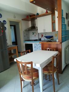 a kitchen with a white table and chairs at Appartamento Bellavista in Moneglia +14 photos