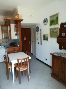 a kitchen with a white table and some chairs at Appartamento Bellavista in Moneglia