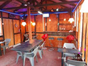 a restaurant with a table and chairs and a bar at Pensiunea Marina in Bran