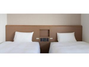 two beds sitting next to each other in a room at R&B Hotel Nagoya Ekimae - Vacation STAY 38775v in Nagoya