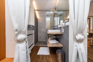 a bathroom with a sink and a mirror at Michis Aparthotel in Flachau +127 photos