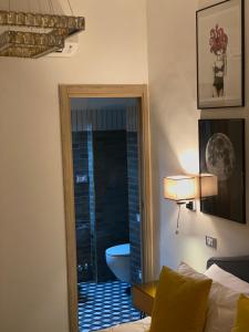 a bedroom with a door to a bathroom with a toilet at Santafe' in Vietri sul Mare +23 photos