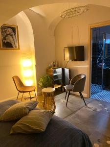 a bedroom with a bed and chairs and a television at Santafe' in Vietri