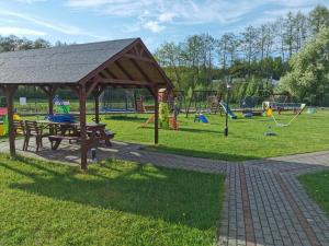 a picnic table and a pavilion in a park at Domki u Bogdana in Dąbki