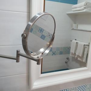 a bathroom with a mirror and a sink at Vittoria Guest House Salerno in Salerno