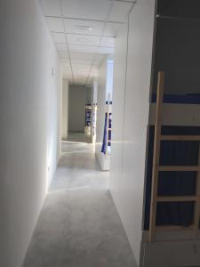 a hallway with a white door and a blue wall at Albergue Casa Calvar in Arcade