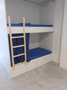 a blue and white bunk bed in a room at Albergue Casa Calvar in Arcade