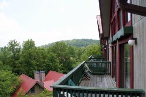 a wooden walkway leading to a balcony of a building at Alpine Crest Resort, a VRI resort in Helen
