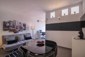 a living room with a couch and a table at SUITE ON 7TH VILAMOURA THE BEST VIEW IN TOWN - 1Br in Quarteira