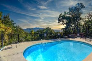 a swimming pool with a view of the mountains at SmokyStays Private Pool Chalet in Gatlinburg